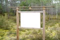 Empty Information white blank sign board panel in the park forest Royalty Free Stock Photo