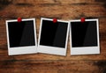 Empty instant photo frames pinned on wooden wall Royalty Free Stock Photo