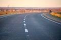 Empty intercity road with asphalt surface and white markings in evening Royalty Free Stock Photo