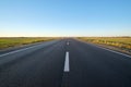 Empty intercity road with asphalt surface and white markings in evening Royalty Free Stock Photo