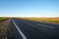 Empty intercity road with asphalt surface and white markings in evening Royalty Free Stock Photo