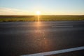 Empty intercity road with asphalt surface and white markings in evening Royalty Free Stock Photo