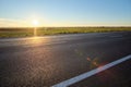 Empty intercity road with asphalt surface and white markings in evening Royalty Free Stock Photo