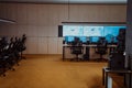 Empty interior of big modern security system control room, workstation with multiple displays, monitoring room with at