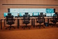 Empty interior of big modern security system control room, workstation with multiple displays, monitoring room with at