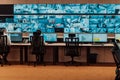 Empty interior of big modern security system control room, workstation with multiple displays, monitoring room with at