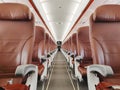 Empty interior cabin of an Airbus A320 Neo with red seats and trim. Many airlines face dire straits as they face a worldwide