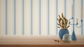 Empty interior design concept, wooden table, desk or shelf close up in blue tones. Ceramic and glass vases with dry plants, straws Royalty Free Stock Photo