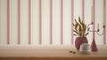 Empty interior design concept, wooden table, desk or shelf close up in red tones. Ceramic and glass vases with dry plants, straws Royalty Free Stock Photo