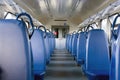 Empty interior of an electric train car. Rows of blue empty seats.Public transport, intercity transport. horizontal photo