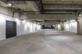 Empty interior of large concrete room as warehouse or hangar with spotlights Royalty Free Stock Photo