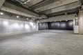 Empty interior of large concrete room as warehouse or hangar with spotlights Royalty Free Stock Photo