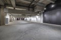 Empty interior of large concrete room as warehouse or hangar with spotlights Royalty Free Stock Photo