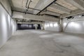 Empty interior of large concrete room as warehouse or hangar with spotlights Royalty Free Stock Photo