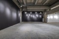 Empty interior of large concrete room as warehouse or hangar with spotlights Royalty Free Stock Photo