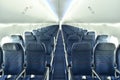 Empty interior of modern airplane Boeing 737-8 Max with blue seats and no passangers. Royalty Free Stock Photo