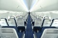 Empty interior of modern airplane Boeing 737-8 Max with blue seats and no passangers. Royalty Free Stock Photo