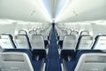 Empty interior of modern airplane Boeing 737-8 Max with blue seats and no passangers.