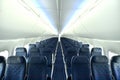 Empty interior of modern airplane Boeing 737-8 Max with blue seats and no passangers. Royalty Free Stock Photo