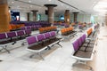 Empty international airport building during pandemic. Empty seat rows at airport lounge