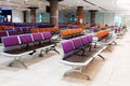 Empty international airport building during pandemic. Empty seat rows at airport lounge