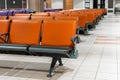 Empty international airport building during pandemic. Empty seat rows at airport lounge