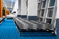 Empty international airport building during pandemic. Empty seat rows at airport lounge