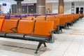 Empty international airport building during pandemic. Empty seat rows at airport lounge