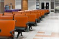 Empty international airport building during pandemic. Empty seat rows at airport lounge