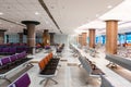 Empty international airport building during pandemic. Empty seat rows at airport lounge