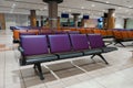 Empty international airport building during pandemic. Empty seat rows at airport lounge