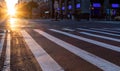 Empty intersection on 14th Street and 5th Avenue with light of sunset shining between the background buildings in New York City