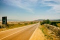 Empty Island Road with Mountains in Distance Royalty Free Stock Photo