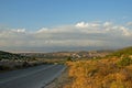 Empty Island Road with Small Village on Hill Royalty Free Stock Photo