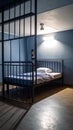 Empty jail cell interior featuring bed blue walls and foreboding metal bars casting shadows Royalty Free Stock Photo