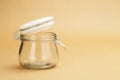 An empty jar with an open white lid Royalty Free Stock Photo