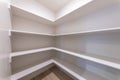 Empty kitchen pantry interior with white shelving units