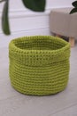 Empty knitted flowerpot cover on floor indoors