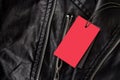 Empty label for text in red color on leather black jacket with metal locks Royalty Free Stock Photo