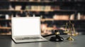 Empty laptop computer screen for savvy design mockup on a table in library Royalty Free Stock Photo