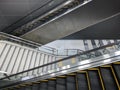 The empty large staircase and the twin new escalator is working to the platform floor in the metro train station