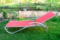 Empty lawn chair, lounge on grass in the garden, backyard in summer vacation Royalty Free Stock Photo