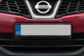 Empty License plate in the front of a red car Royalty Free Stock Photo