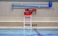 Empty lifeguard chair by an indoor pool