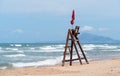 Empty lifeguard high seat along ocean with high waves in Daimus, Spain