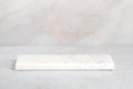 Empty light marble podium for product display on gray background