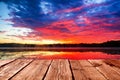 Empty light wood table or rustic wooden planks against colorful sunset sky sea background. Space for your background placement or Royalty Free Stock Photo