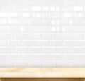 Empty light wood table and white ceramic tile brick wall in back Royalty Free Stock Photo