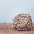 Empty little birds nest isolated on a wooden floor Royalty Free Stock Photo
