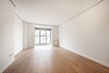 Empty living room with big window in the background, wooden floors Royalty Free Stock Photo